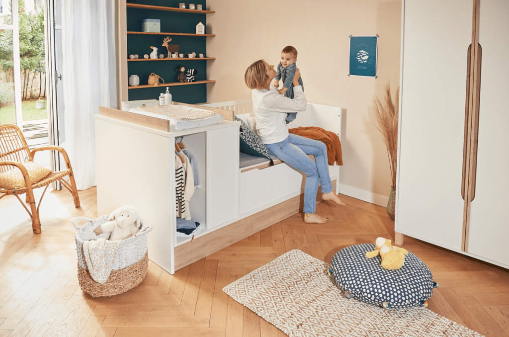 Une chambre de bébé avec un berceau, une commode et une bibliothèque.