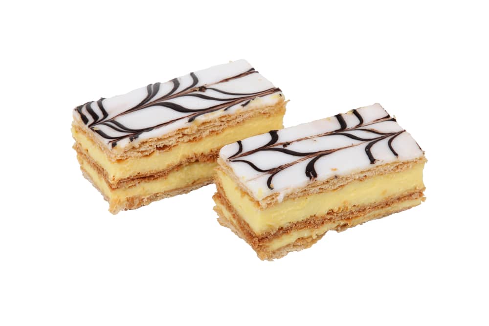Deux mille-feuilles, un blanc et un jaune, sur fond blanc.